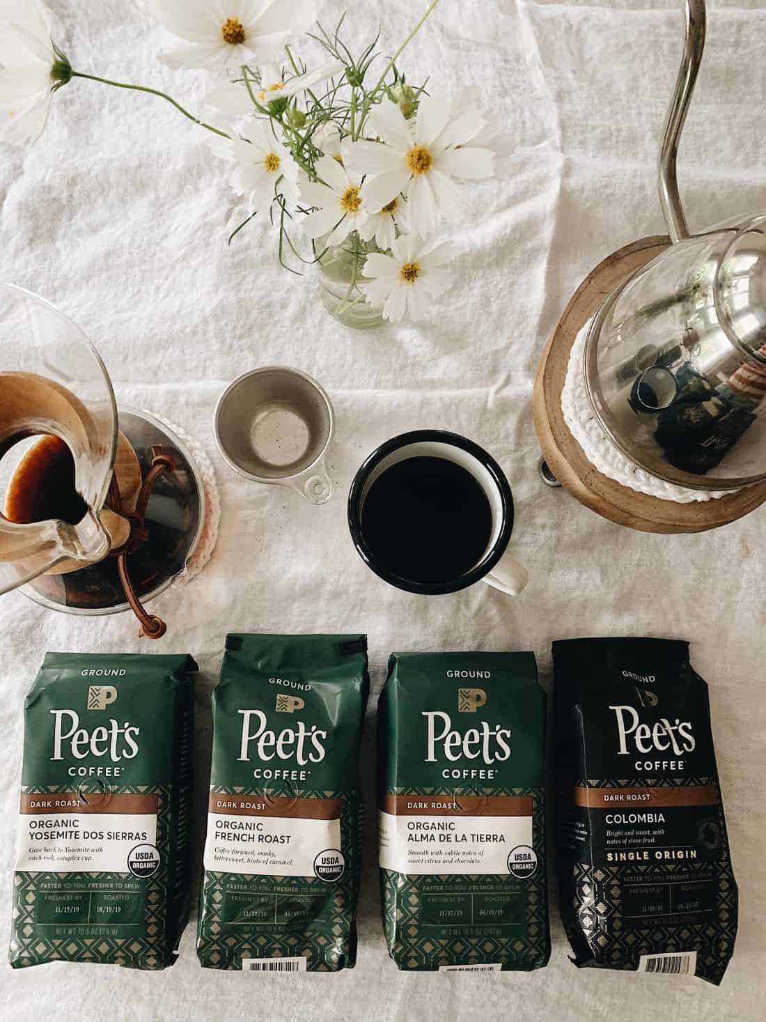 four bags of whole bean coffee laying on a table