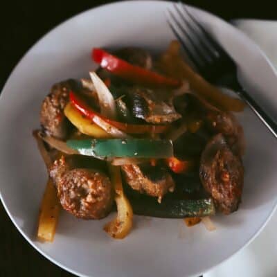 italian sausage and peppers on white plate