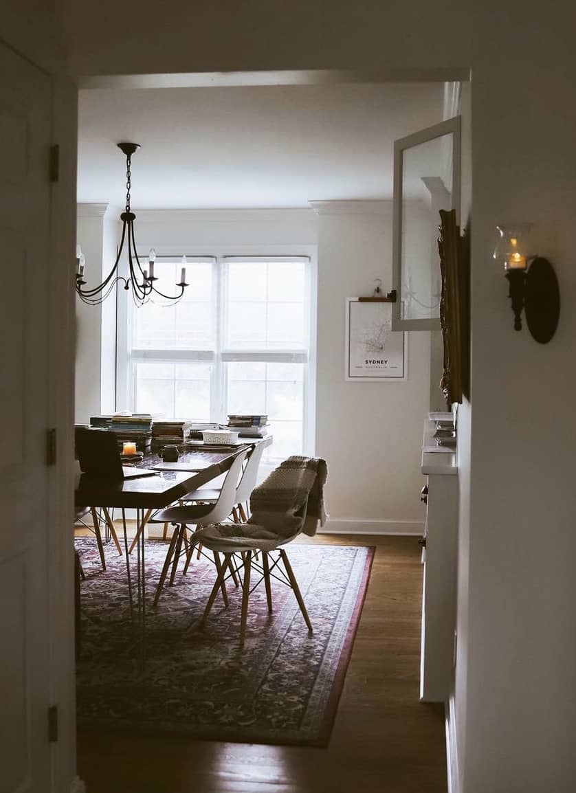 a dining table with stacks of book on top of it