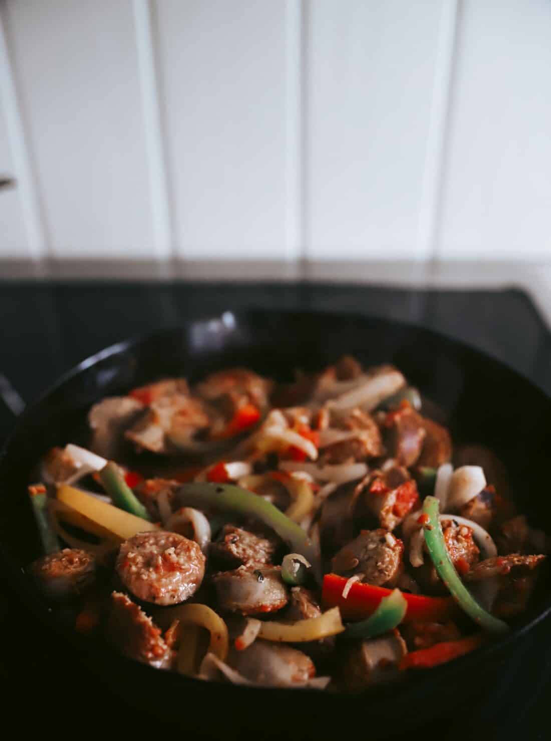 italian sausage and peppers in a cast iron