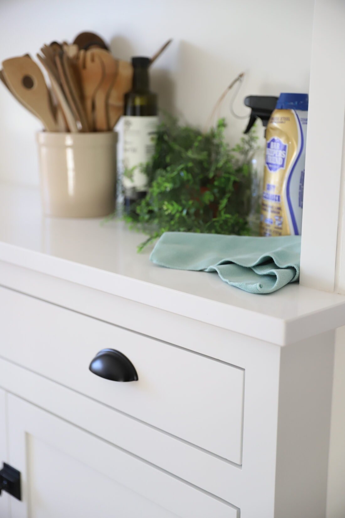 white quartz counters with green plants and cleaning products
