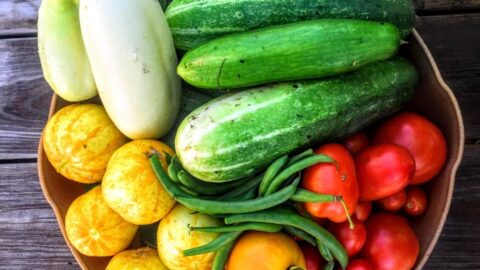 basket full of green and red vegetables
