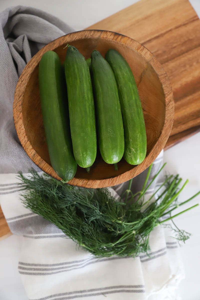 whole cucumbers in a wooden bowl