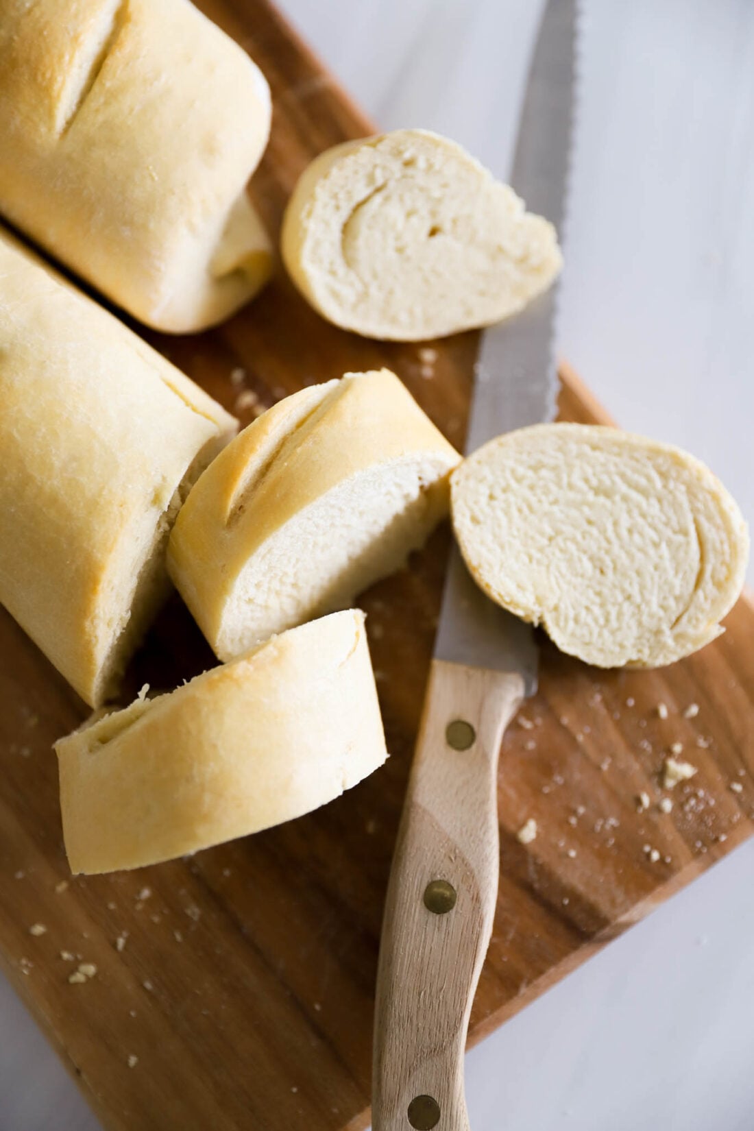 Sliced baguette on a cutting board.