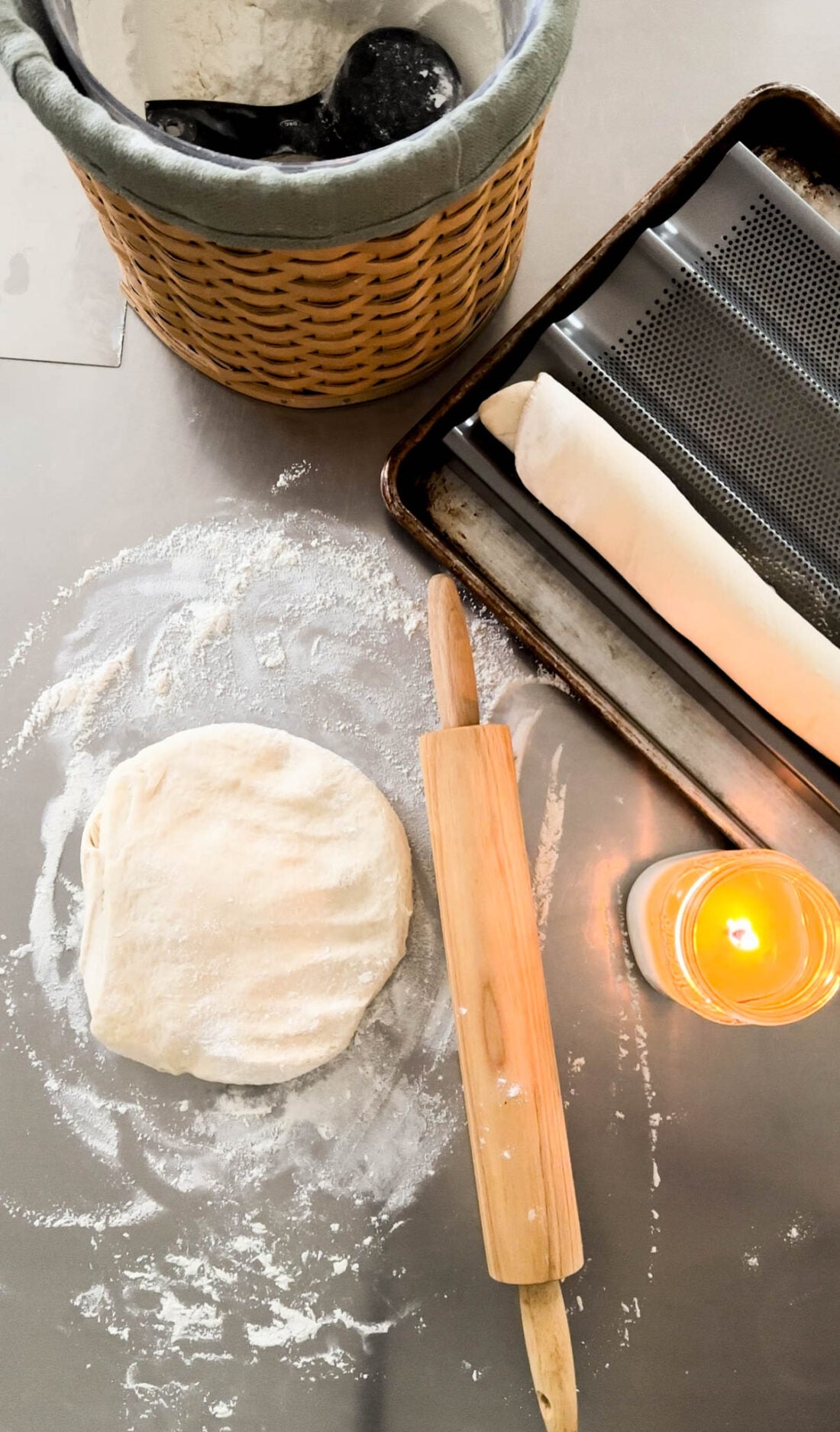 Hands rolling out bread dough.