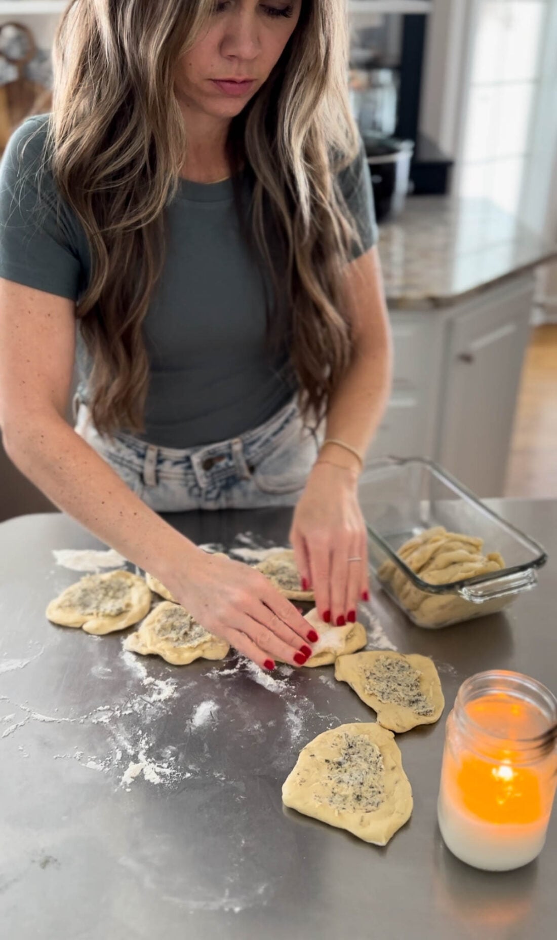 Woman making bread on a counter.