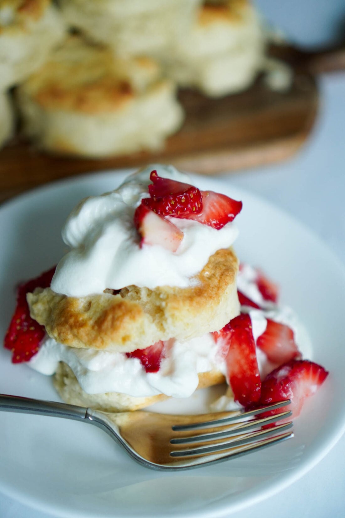 Strawberry shortcake on a white plate with a fork.