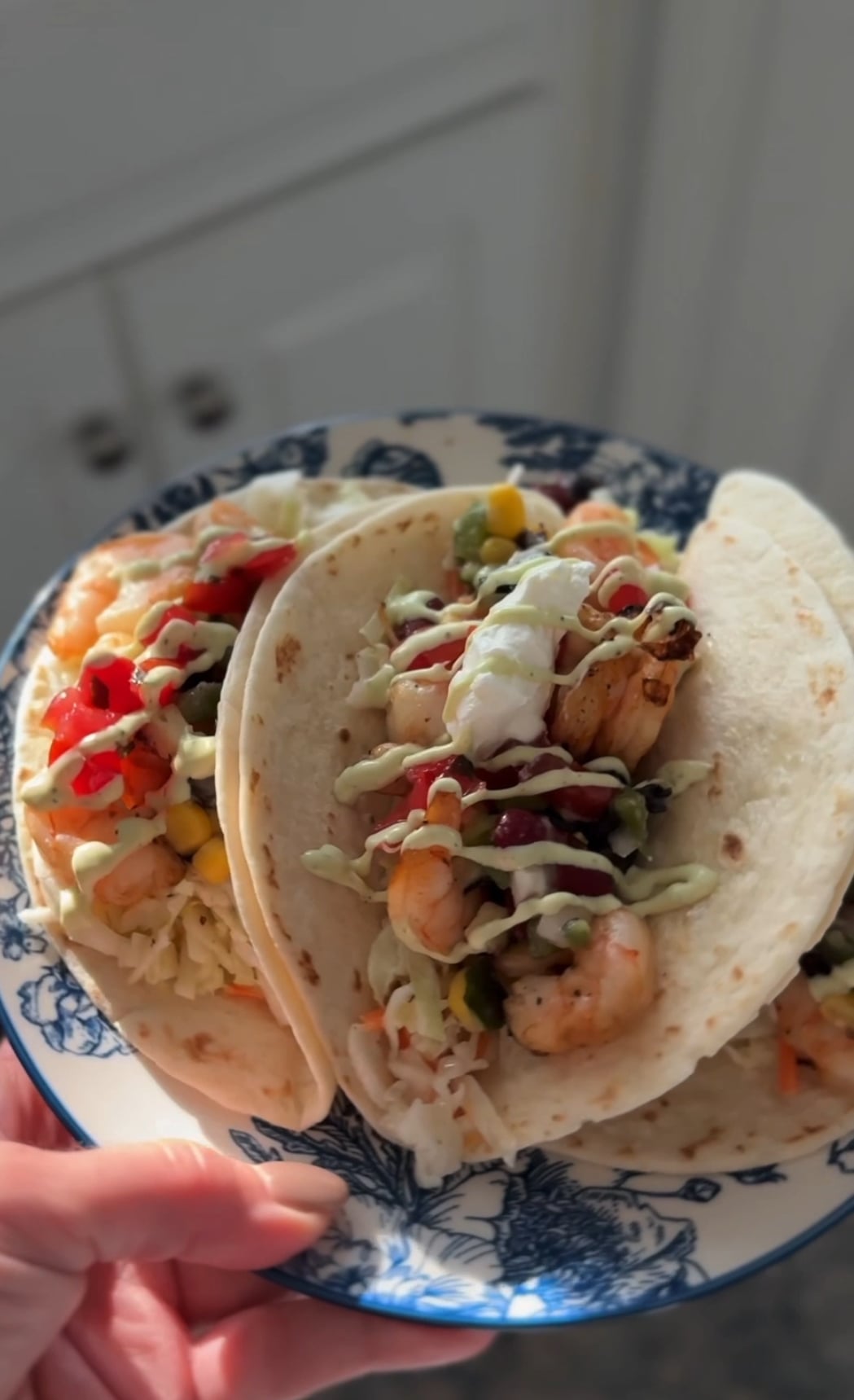shrimp tacos on a blue and white plate